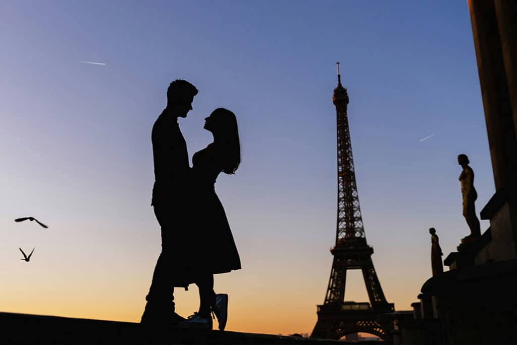 A couple in front of the Eiffel Tower in Paris